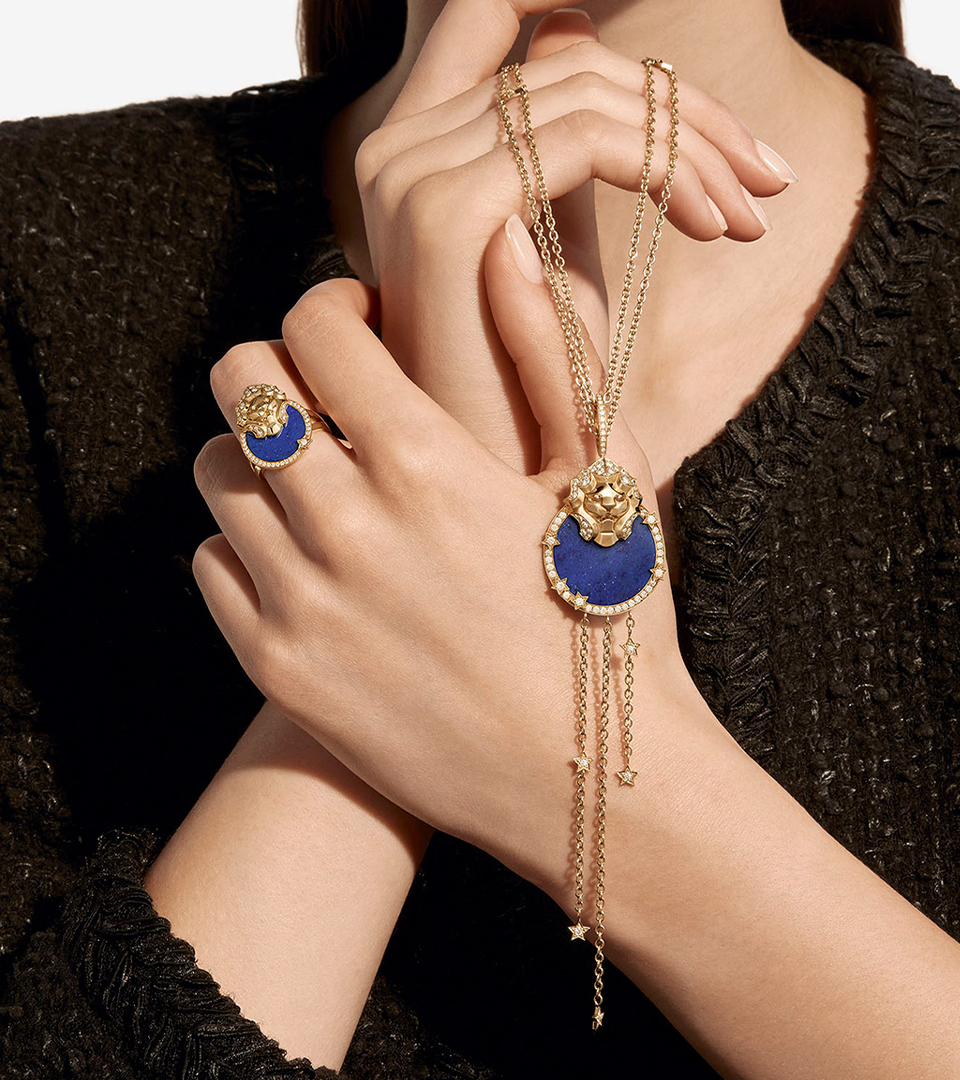 Photography of a model waering Chanel lion jewellery with lapis lazuli semi-precious stone