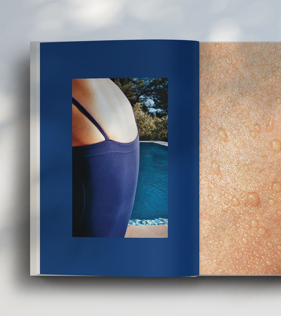 Open book on a double page with analog photographies of a swimsuit worn by a girl near a swimming pool and a close up skin texture with body oil and water drop