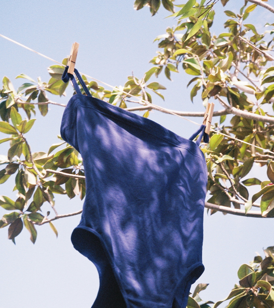 Analog photography of a Eres swimsuit on a rack in a garden of south of France